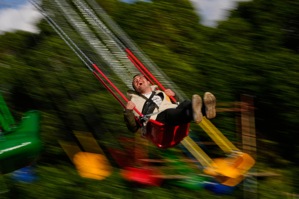 A young man enjoys a swing ride at an amusement park as he celebrates Eid al-Fitr, marking the end of the Muslim holy fasting month of Ramadan, in Beirut, Lebanon, Friday, March 20, 2026. (AP Photo/Hassan Ammar)