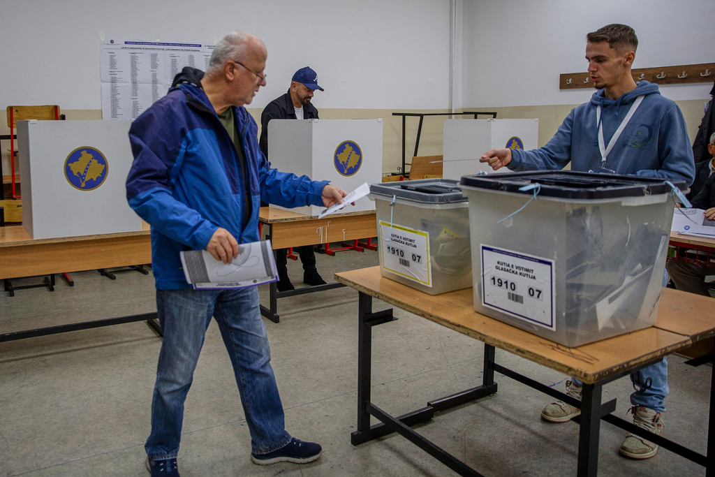 Voters cast their ballot for the municipal elections in Pristina, Kosovo on Sunday, Oct. 12, 2025. (AP Photo/Visar Kryeziu)