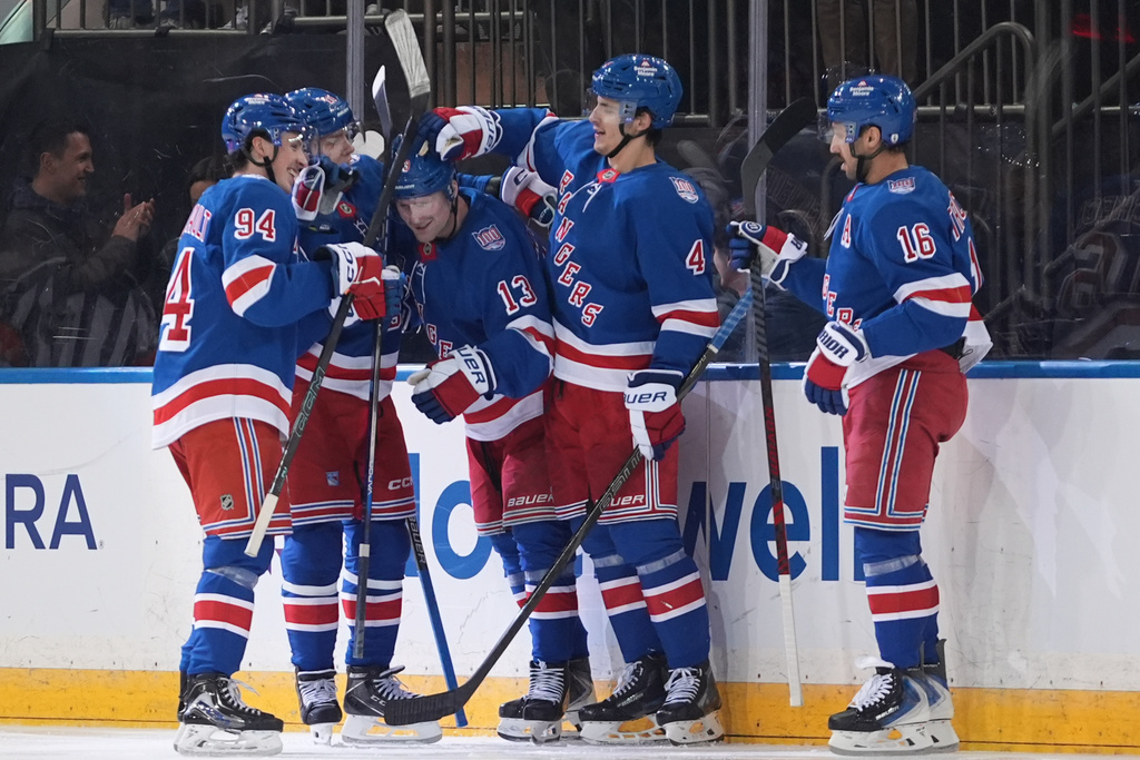 New York Rangers' Alexis Lafrenière (13) celebrates with teammates after scoring a goal during the second period of an NHL hockey game against the Nashville Predators Monday, Nov. 10, 2025, in New York. (AP Photo/Frank Franklin II)
