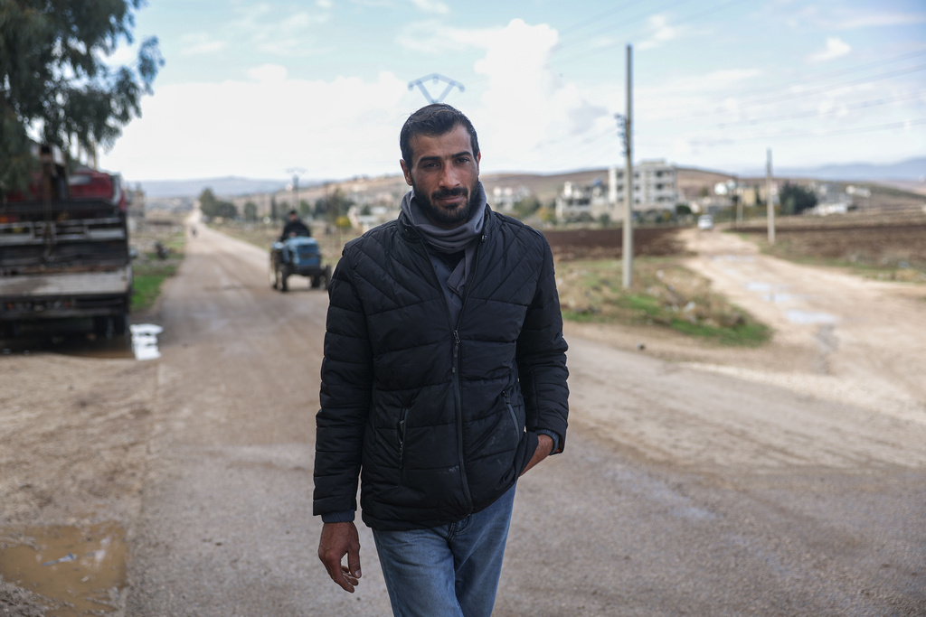Former detainee Mohammad Marwan walks down a street on his way to the Homs Recovery Center in the village of Tell Dahab in the Homs countryside, Syria, Tuesday, Dec. 2, 2025. (AP Photo/Ghaith Alsayed)