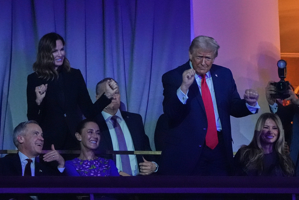 President Donald Trump dances toThe Village People as Canadian Prime Minister Mark Carney, Mexican President Claudia Sheinbaum and First Lady Melania smile during the draw for the 2026 soccer World Cup at the Kennedy Center in Washington, Friday, Dec. 5, 2025. (AP Photo/Jacquelyn Martin)