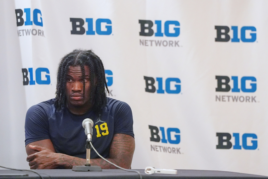 Michigan quarterback Bryce Underwood talks to reporters after an NCAA college football game against Minnesota Saturday, Oct. 3, 2026, in Minneapolis. (AP Photo/Abbie Parr)