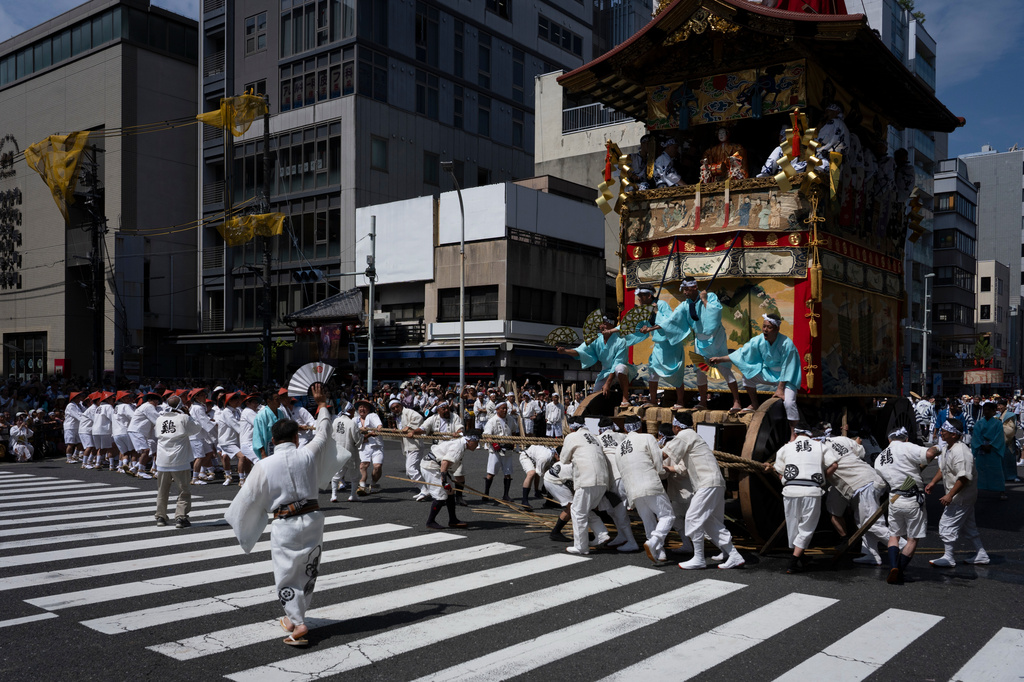 People carry the "Niwatori Hoko" float during one of the main parades of Shinto's Gion Matsuri festival in Kyoto, western Japan, Friday, July 17, 2026. (AP Photo/Fred Mery)