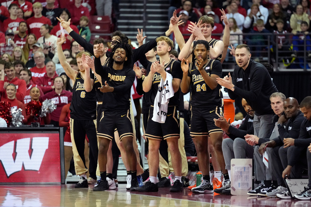 The Purdue bench react to a three-point basket scored by Purdue guard C.J. Cox (0) during the first half of an NCAA college basketball game against Wisconsin Saturday, Jan. 3, 2026, in Madison, Wis. (AP Photo/Kayla Wolf)