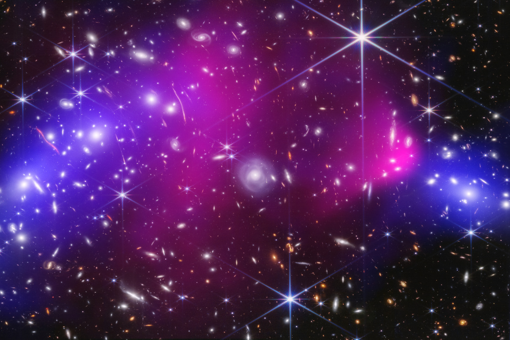 FILE - This image provided by NASA shows two massive galaxy clusters captured by NASA's James Webb Space Telescope and Chandra X-ray Observatory in Jan. 20, 2025, with areas of possible dark matter indicated in blue. (NASA, ESA, CSA, STScI, CXC; Science: James Jee (Yonsei University, UC Davis), Sangjun Cha (Yonsei University), Kyle Finner (Caltech/IPAC) via AP, File)