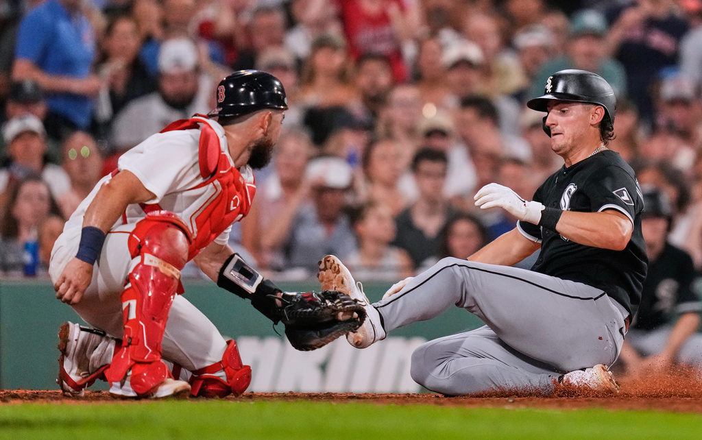 Chicago White Sox's Colson Montgomery, right, beats the tag by Boston Red Sox's Connor Wong to score on a single Braden Montgomery during the fifth inning of a baseball game, Thursday, Aug. 6, 2026, in Boston. (AP Photo/Charles Krupa)