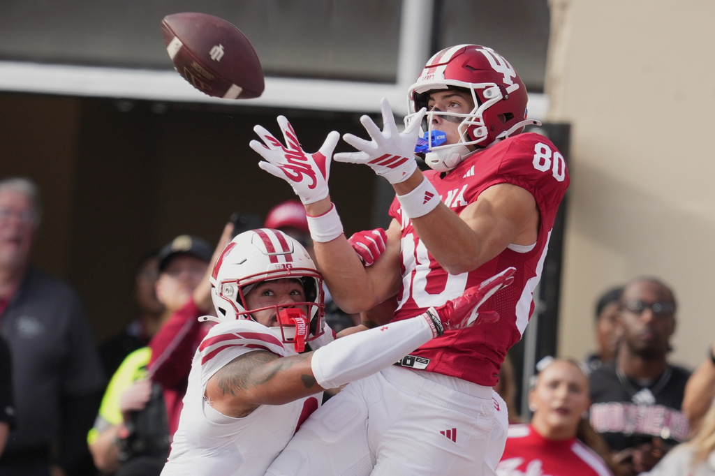 FILE - Indiana wide receiver Charlie Becker makes a touchdown catch over Wisconsin safety Austin Brown (9) during the first half of an NCAA college football game, Saturday, Nov. 15, 2025, in Bloomington, Ind. (AP Photo/Darron Cummings, file)