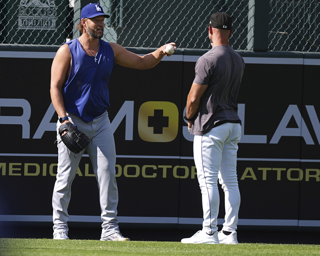 Los Angeles Dodgers pitcher Clayton Kershaw, left, chats with Colorado Rockies interim manager Warren Schaeffer before a baseball game Tuesday, Aug. 19, 2025, in Denver. (AP Photo/David Zalubowski)