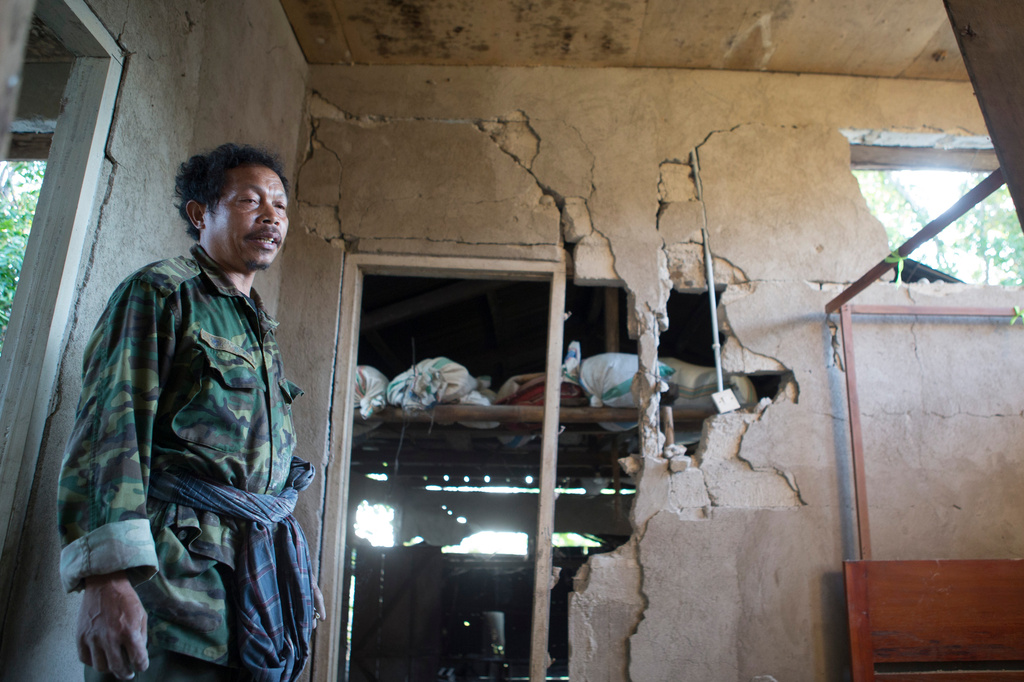 A man stands inside his earthquake-damaged house in Mbeliling, East Nusa Tenggara province, Indonesia, Sunday, Aug. 16, 2026. (AP Photo/Firdia Lisnawati)