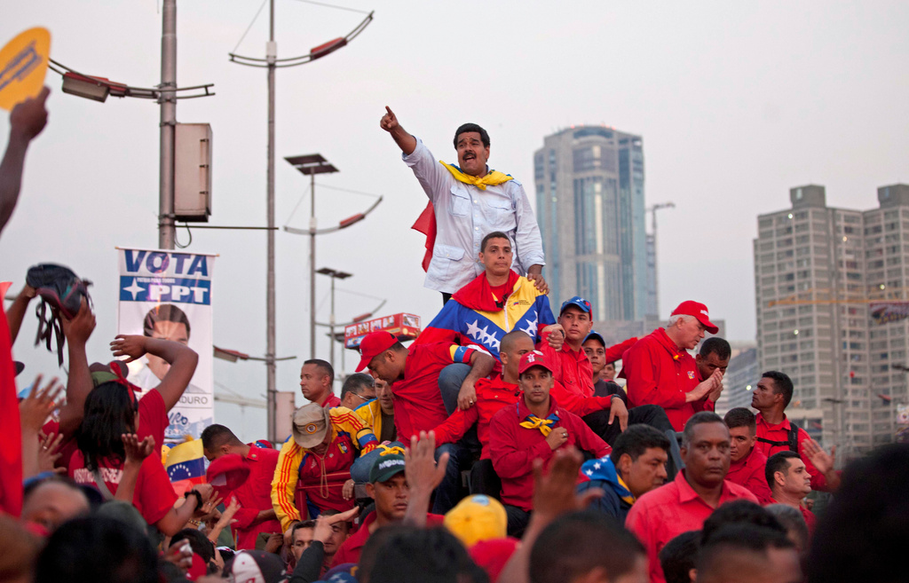 FILE - Venezuela's acting President Nicolas Maduro greets supporters as he arrives to Bolivar Ave. for his closing campaign rally in Caracas, Venezuela, April 11, 2013. Maduro, the hand-picked successor of Venezuela's late President Hugo Chavez, defeated opposition candidate Henrique Capriles in the April 14th election. (AP photo/Ramon Espinosa, File)