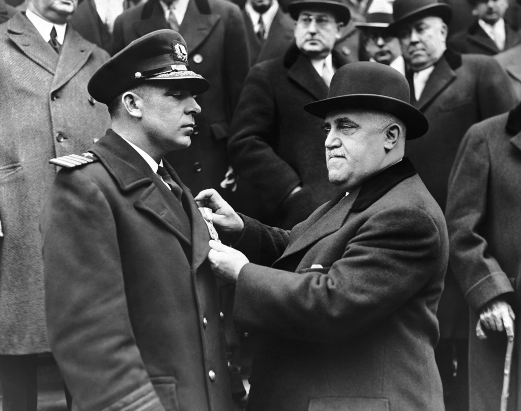FILE - New York Mayor John P. O'Brien pins an honor medal on Capt. Giles Stedman, on the steps of New York City Hall, Jan. 27, 1933, in New York. (AP File Photo)