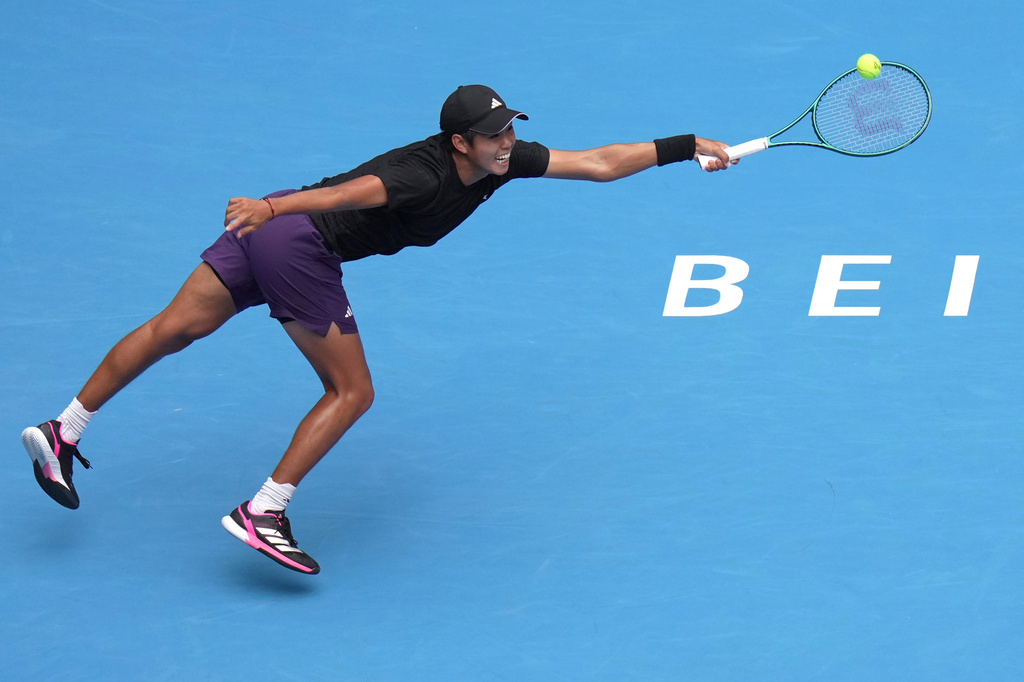 Learner Tien of the United States returns a shot from Jannik Sinner of Italy in the men's singles final match for the China Open tennis tournament in Beijing on Wednesday, Oct. 1, 2025. (AP Photo/Andy Wong)