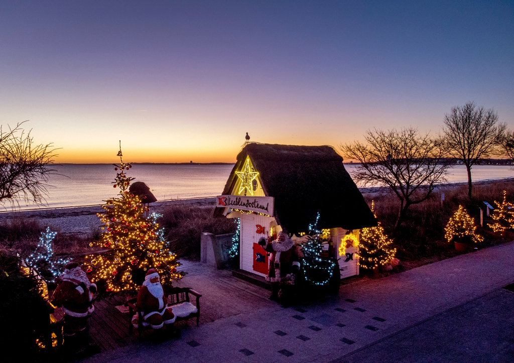 FILE - Christmas trees and Santa Clauses decorate the entrance to the beach in Haffkrug, northern Germany, Monday, Dec. 20, 2021. (Photo/Michael Probst, File)