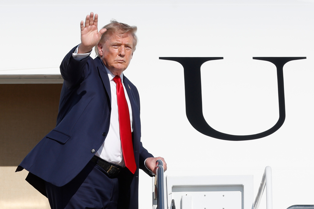 President Donald Trump waves was he boards Air Force One upon his departure at Joint Base Andrews, Md., Friday, Aug. 21, 2026. (AP Photo/Luis M. Alvarez)