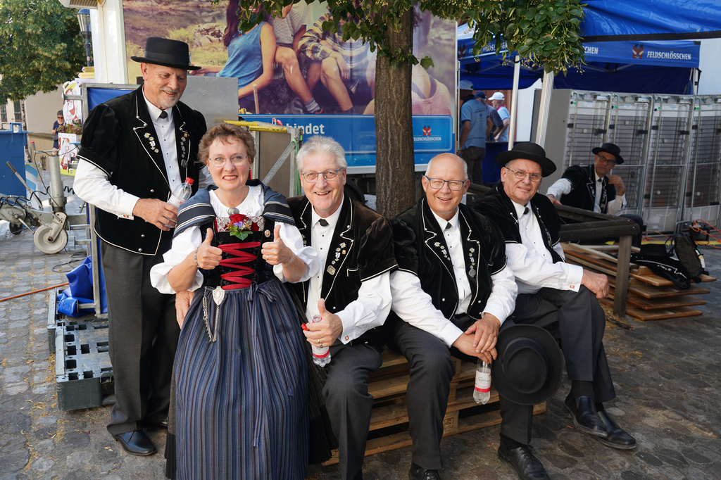 A group of yodellers stay cool in the shade outside the Martins church in Basel, Switzerland, Saturday, June 27, 2026. (AP Photo/Jez Fielder)