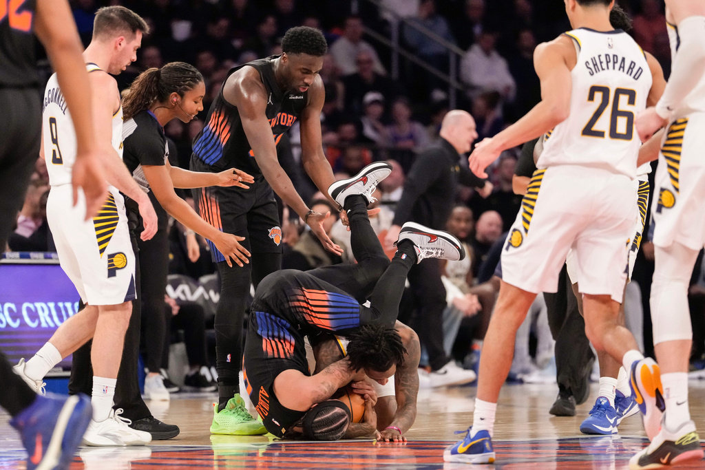 New York Knicks guard Jose Alvarado, top-bottom, fights for control of the ball with Indiana Pacers guard Quenton Jackson during the first half of an NBA basketball game, Tuesday, Feb. 10, 2026, in New York. (AP Photo/Yuki Iwamura)