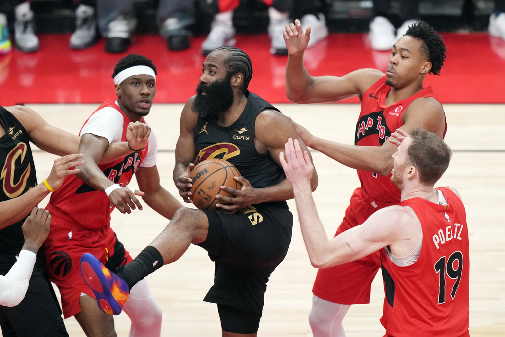 Cleveland Cavaliers' James Harden (1) is surround by Toronto Raptors during the first half of Game 6 in the first round of an NBA basketball playoffs series in Toronto on Friday, May 1, 2026. (Nathan Denette/The Canadian Press via AP)