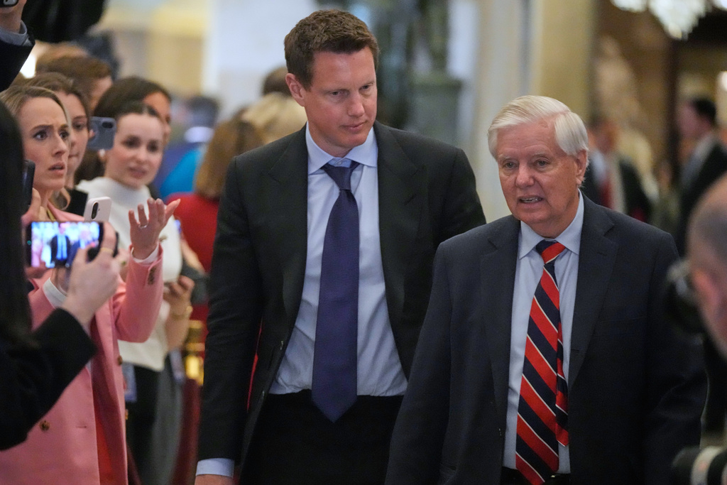 Paramount Skydance chairman and CEO David Ellison arrives with Sen. Lindsey Graham, R-S.C., before President Donald Trump delivers the State of the Union address to a joint session of Congress in the House chamber at the U.S. Capitol in Washington, Tuesday, Feb. 24, 2026. (AP Photo/Mark Schiefelbein)