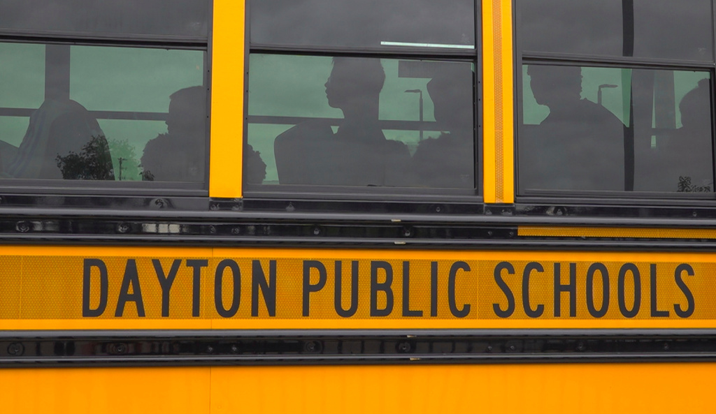This video taken from photos shows students boarding a school bus on Thursday, August 21, 2025 in Dayton, Ohio. (AP Photo/Patrick Aftoora-Orsagos)