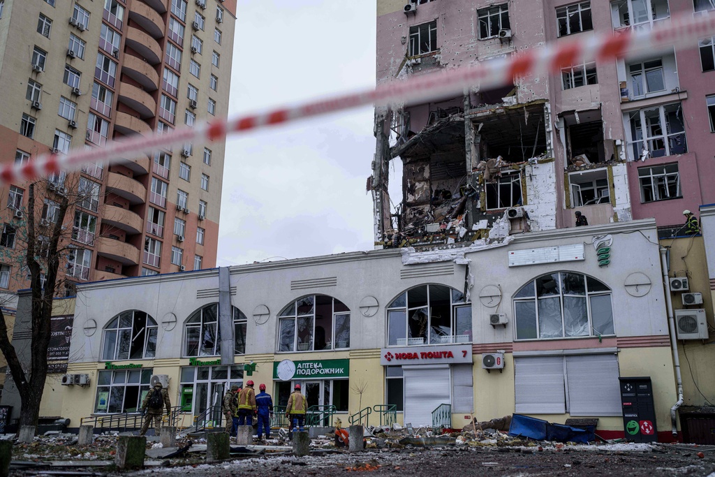 Rescue workers clear the rubble of a residential building which was heavily damaged after a Russian strike on Kyiv, Ukraine, on Saturday, Dec. 27, 2025. (AP Photo/Evgeniy Maloletka)