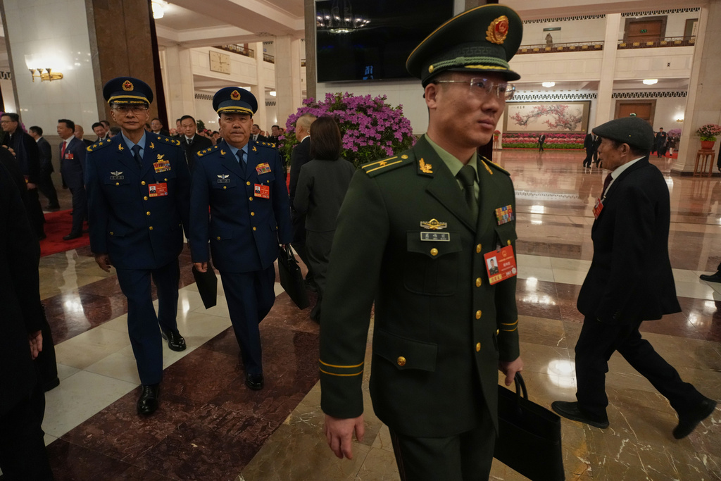 Military delegates leave after a pre-session of the National People's Congress (NPC) at the Great Hall of the People, in Beijing, China, Wednesday, March 4, 2026. (AP Photo/Ng Han Guan)