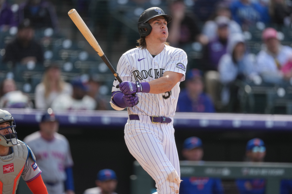 Colorado Rockies' Jake McCarthy follows the flight of his grand slam off New York Mets relief pitcher Craig Kimbrel in the eighth inning of a baseball game, Thursday, May 7, 2026, in Denver. (AP Photo/David Zalubowski)