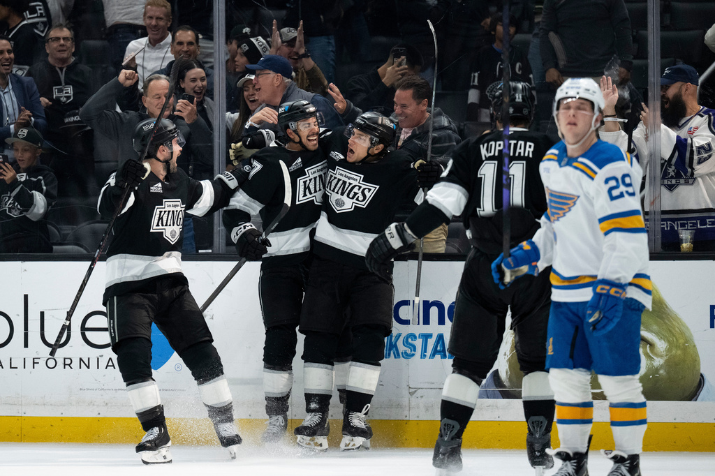 Los Angeles Kings left wing Trevor Moore, center, celebrates his game-winning goal with his teammates during overtime in an NHL hockey game against the St. Louis Blues, Wednesday, April 1, 2026, in Los Angeles. (AP Photo/Kyusung Gong)