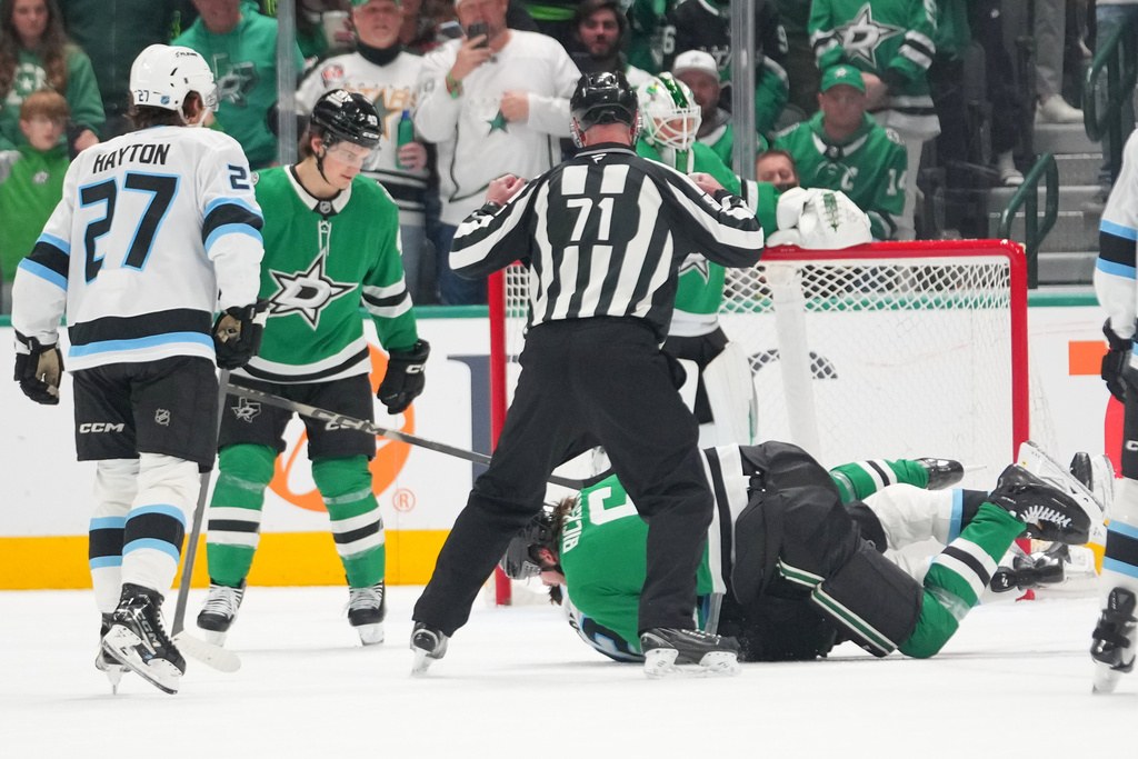 Dallas Stars defenseman Lian Bichsel, bottom, fights with Utah Mammoth center Jack McBain during the first period of an NHL hockey game Monday, March 16, 2026, in Dallas. (AP Photo/Julio Cortez)