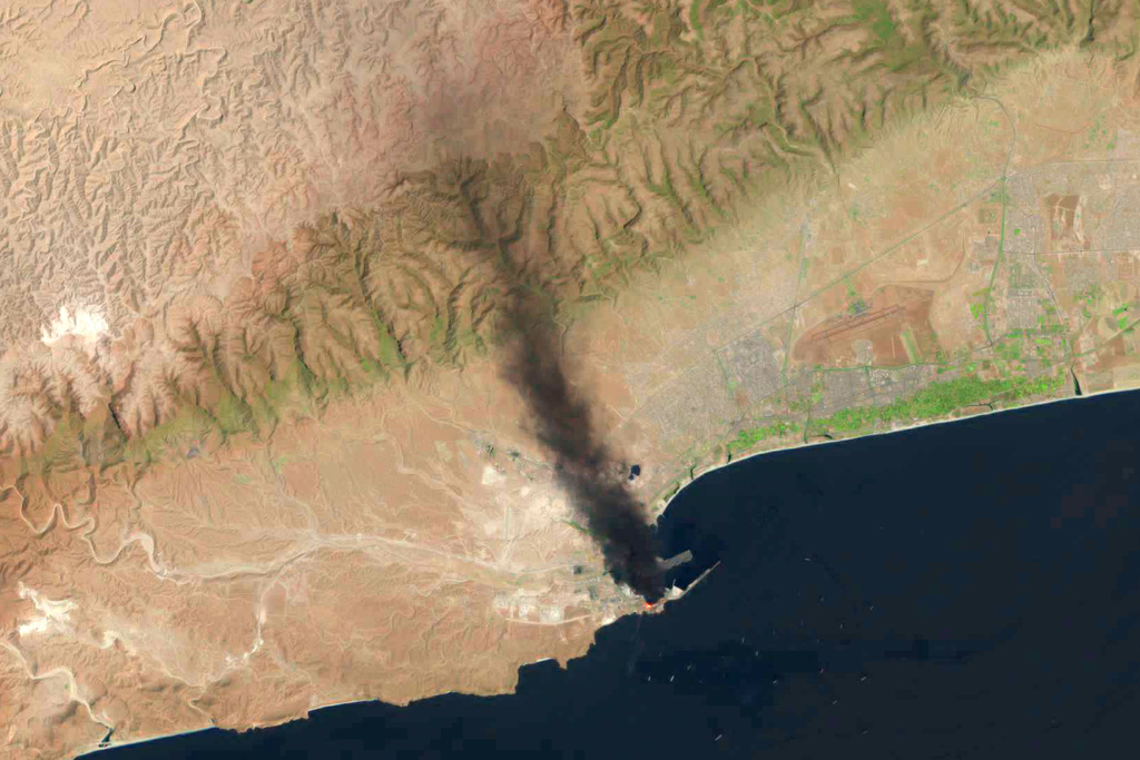 This satellite image taken by a U.S. Geological Survey Landsat satellite shows a fire days after a suspected Iranian attack targeting the port in Salalah, Oman, Monday, March 16, 2026. (U.S. Geological Survey via AP)