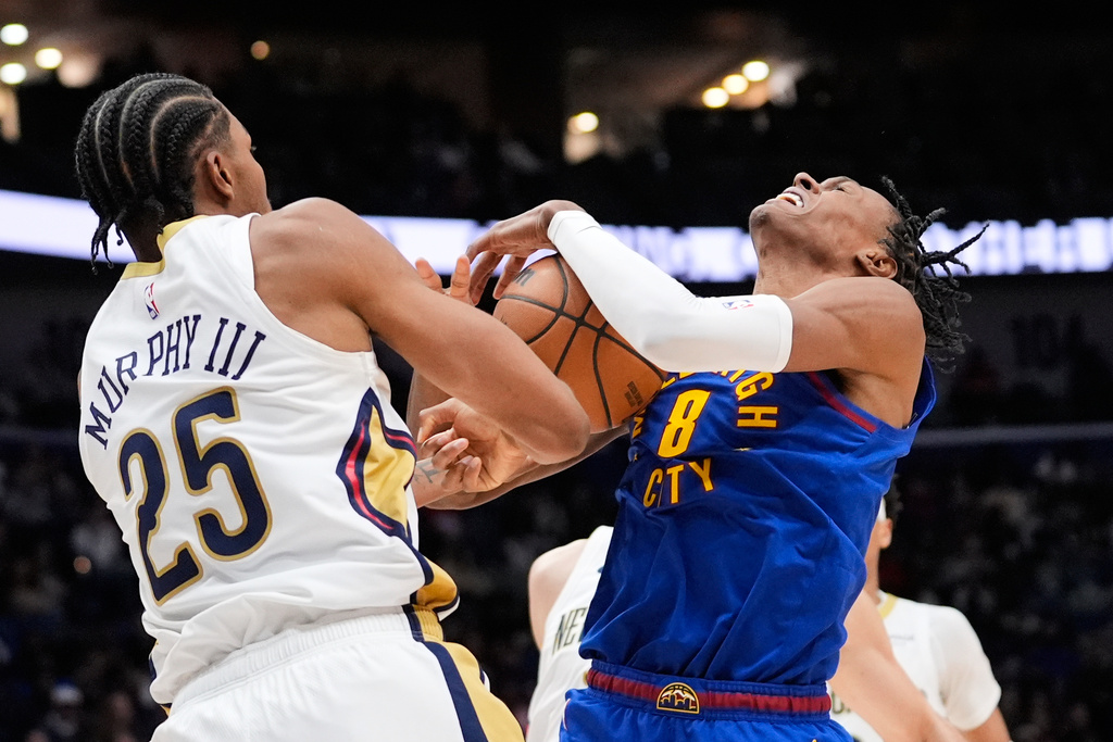 Denver Nuggets guard Peyton Watson (8) battles for the ball against New Orleans Pelicans forward Trey Murphy III (25) in the second half of an NBA basketball game, Tuesday, Jan. 13, 2026, in New Orleans. (AP Photo/Gerald Herbert)