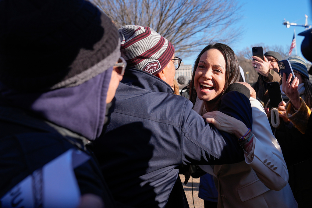 Venezuelan opposition leader MarÌa Corina Machado greets supporters on Pennsylvania Avenue near the White House after meeting with President Donald Trump Thursday, Jan. 15, 2026, in Washington. (AP Photo/Pablo Martinez Monsivais)