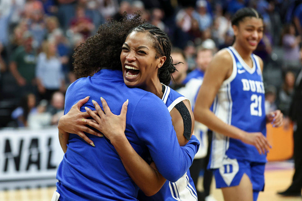 Duke guard Ashlon Jackson (3) and head coach Kara Lawson celebrate after the Sweet 16 of the NCAA college basketball tournament against LSU Friday, March 27, 2026, in Sacramento, Calif. (AP Photo/Sara Nevis)