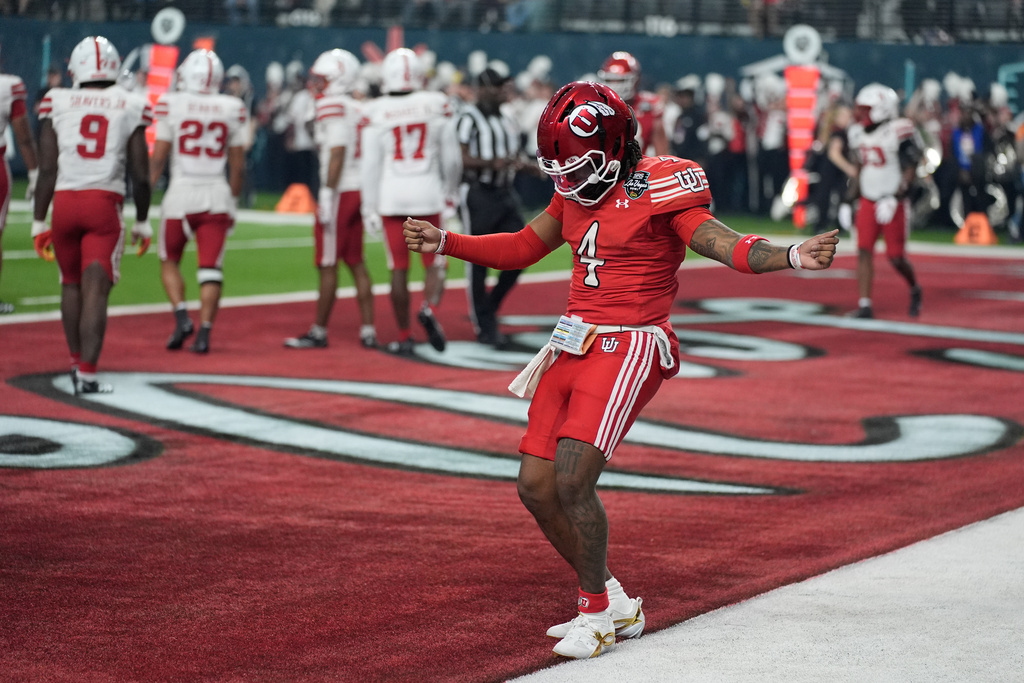Utah quarterback Devon Dampier (4) celebrates after scoring a touchdown against Nebraska during the first half of the Las Vegas Bowl NCAA college football game Wednesday, Dec. 31, 2025, in Las Vegas. (AP Photo/John Locher)