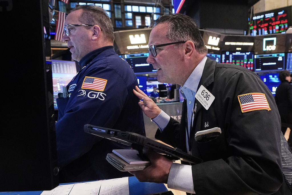 Specialist Anthony Matesic, left, and trader Edward Curran work on the floor of the New York Stock Exchange, Wednesday, Jan. 21, 2026. (AP Photo/Richard Drew)