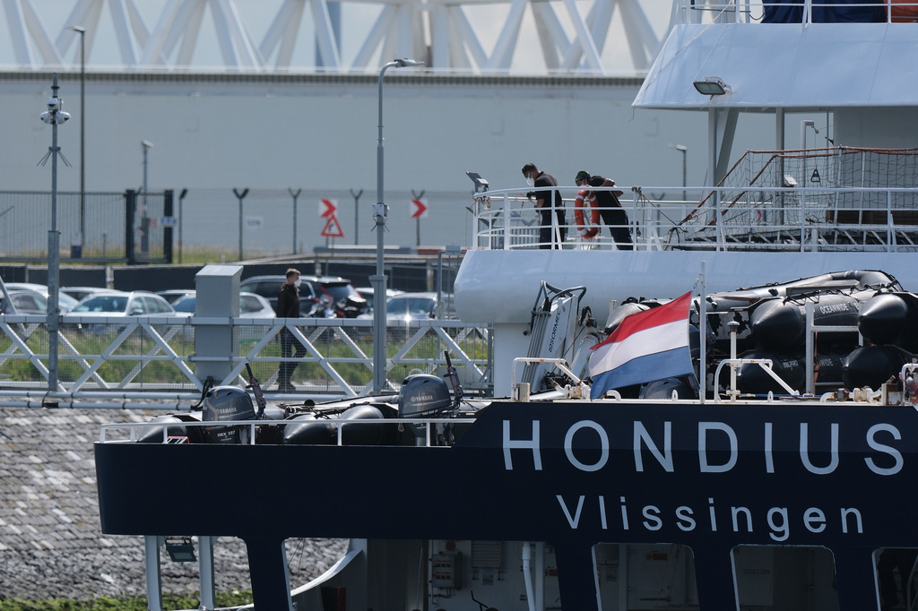 Workers on board as the MV Hondius cruise ship arrives at the Port of Rotterdam, Netherlands, Monday, May 18, 2026. (AP Photo/Patrick Post)