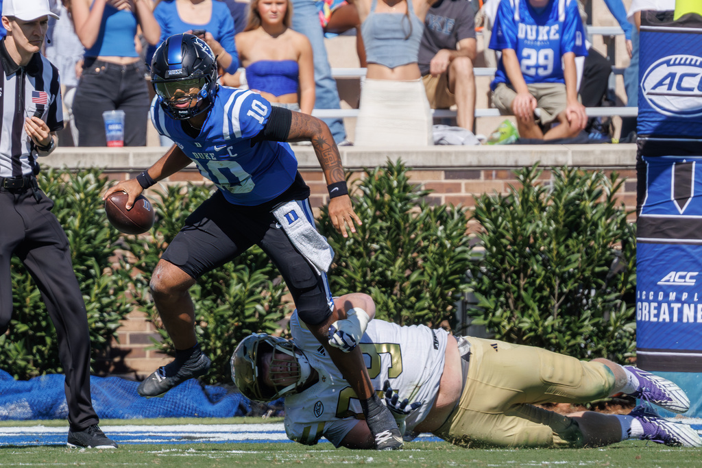 Duke's Darian Mensah (10) scrambles away from Georgia Tech's Jordan van den Berg (99) during the first half of an NCAA college football game in Durham, N.C., Saturday, Oct. 18, 2025. (AP Photo/Ben McKeown)