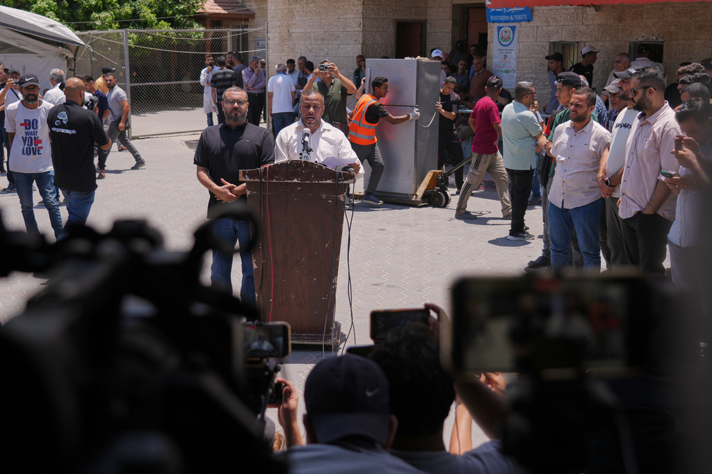 Ismail al-Thawabta, general director of the Hamas-run government media office, center right, speaks during a press conference at Al-Aqsa Hospital in Deir al-Balah, central Gaza Strip, Monday, July 6, 2026. (AP Photo/Jehad Alshrafi)