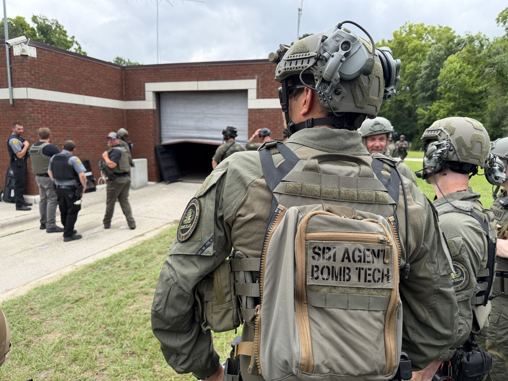 In this photo provided by the North Carolina State Bureau of Investigation, law enforcement officers wait outside the Bertie-Martin Regional Detention Center on Monday, June 29, 2026, in Windsor, N.C. (North Carolina Bureau State Bureau of Investigation via AP)
