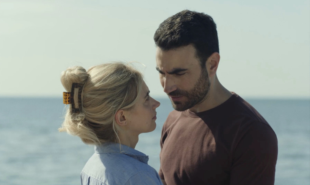 This image released by Apple TV+ shows Brett Goldstein, right, and Imogen Poots in a scene from "All of You." (Tereza Cervenova/Apple TV+ via AP)