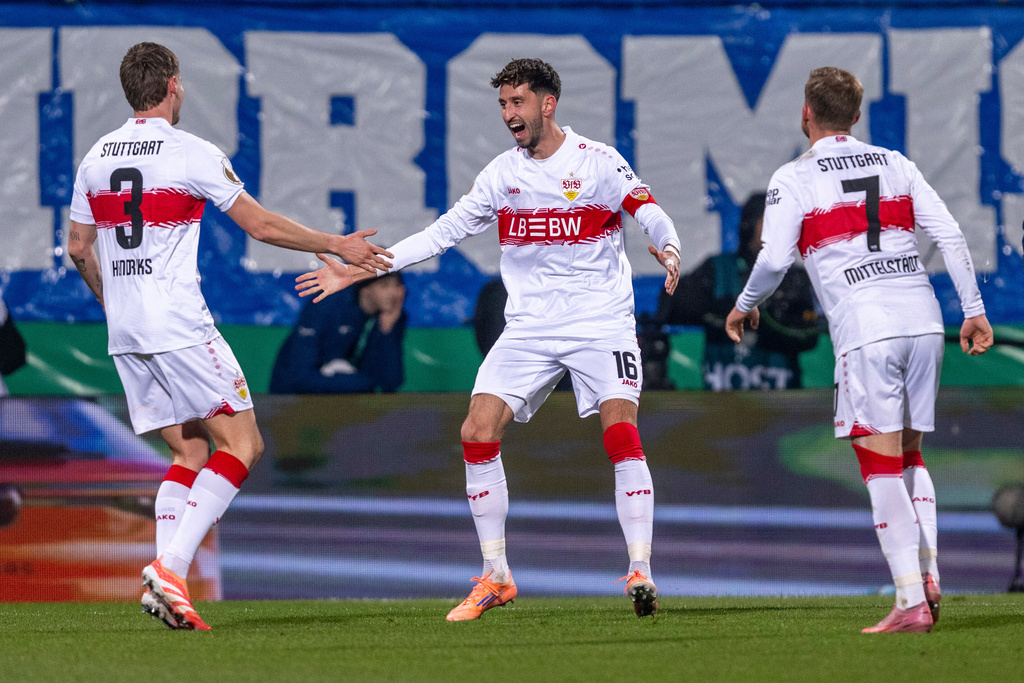From left, Stuttgart's Ramon Hendriks, Atakan Karazor and Maximilian Mittelstaedt celebrate Bochum's own goal during the German soccer cup round of sixteen match beween VfL Bochum and VfB Stuttgart in Bochum, Germany, Wednesday, Dec. 3, 2025. (David Inderlied/dpa via AP)