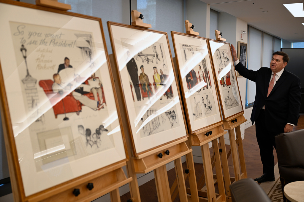 Stewart McLaurin, president of the White House Historical Association, displays a newly-acquired suite of four interrelated paintings by Norman Rockwell titled, "So You Want to See the President!" at the association's offices Wednesday, June 10, 2026, in Washington. (AP Photo/John McDonnell)