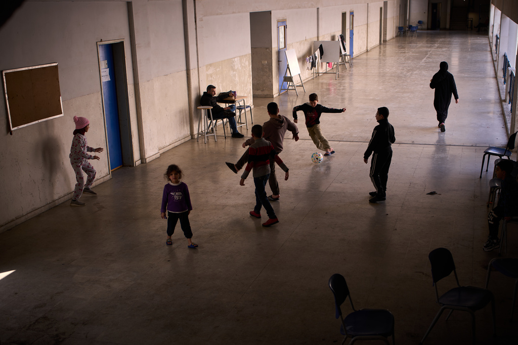 Displaced children from Beirut's southern suburbs play soccer inside a school converted into a shelter in Beirut, Lebanon, Friday, March 27, 2026. (AP Photo/Emilio Morenatti)