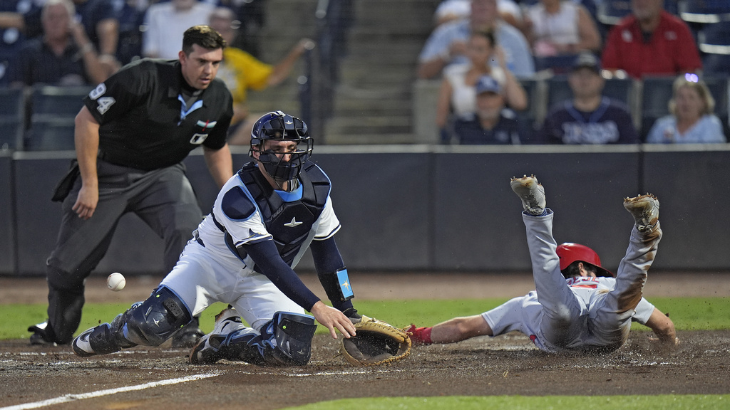 St. Louis Cardinals' Thomas Saggese, right, scores as the throw skips away from Tampa Bay Rays catcher Nick Fortes on a fielder's choice by Nathan Church during the second inning of a baseball game Thursday, Aug. 21, 2025, in Tampa, Fla. (AP Photo/Chris O'Meara)