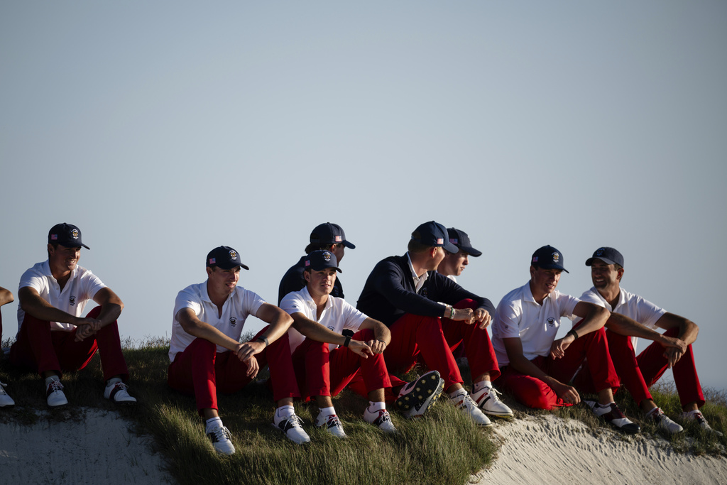The USA team players watch from the 17th green as they play the Great Britain and Ireland team during Walker Cup golf matches at Cypress Point Club, Saturday, Sept. 6, 2025, in Pebble Beach, Calif. (AP Photo/Thien-An Truong)