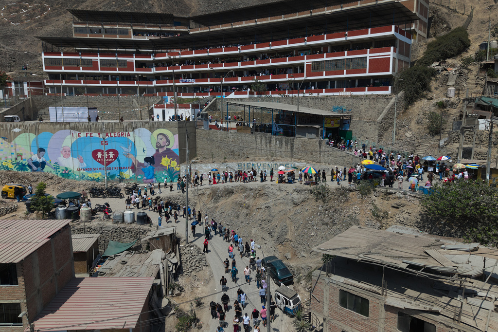 Voters line up outside a polling station during general elections in Lima, Peru, Sunday, April 12, 2026. (AP Photo/Guadalupe Pardo)