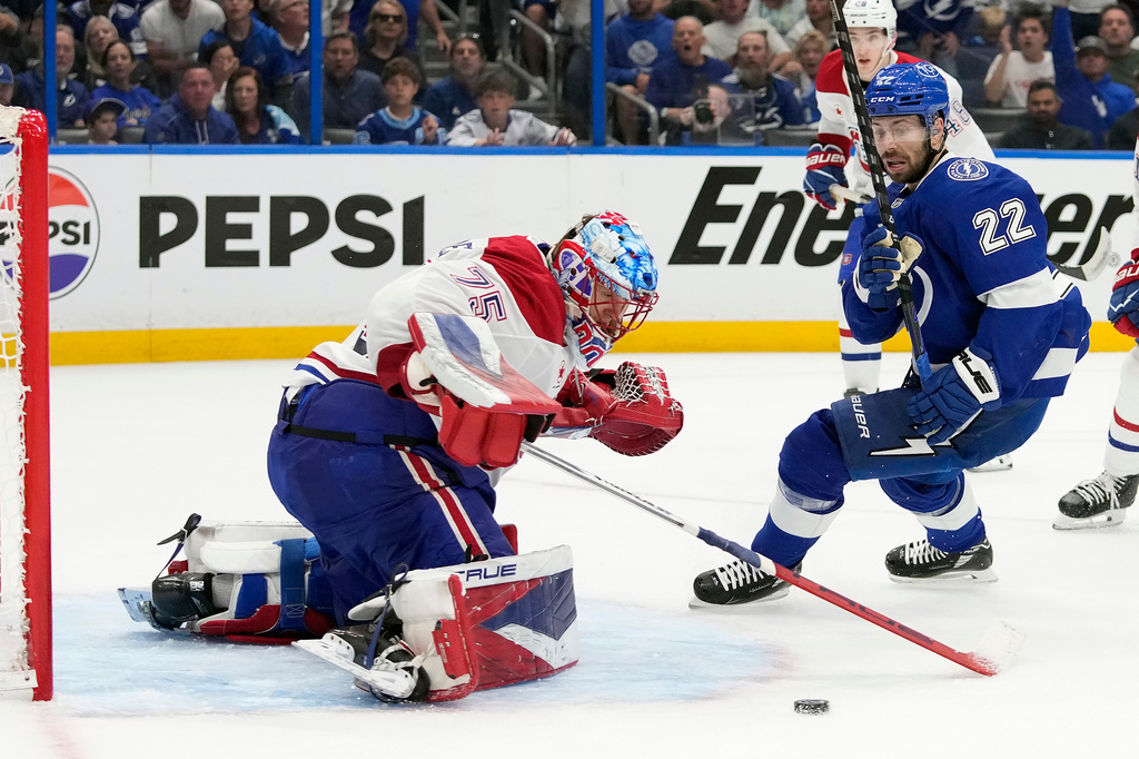 Montréal Canadiens goaltender Jakub Dobes (75) stops a shot by Tampa Bay Lightning right wing Oliver Bjorkstrand (22) during the second period in Game 5 of an NHL hockey Stanley Cup first-round playoff series, Wednesday, April 29, 2026, in Tampa, Fla. (AP Photo/Chris O'Meara)