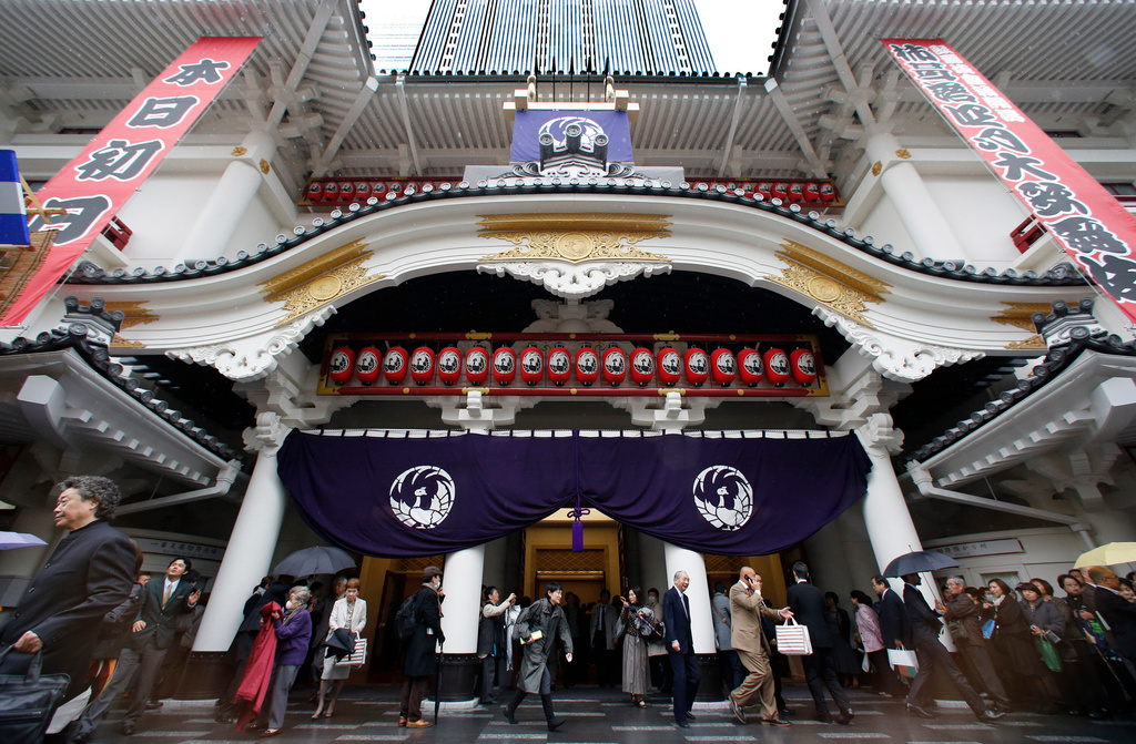 FILE - People walk out from newly-refurbished Kabukiza Theatre on its opening day in Tokyo Tuesday, April 2, 2013, following a three-year renovation work. (AP Photo/Shizuo Kambayashi, File)