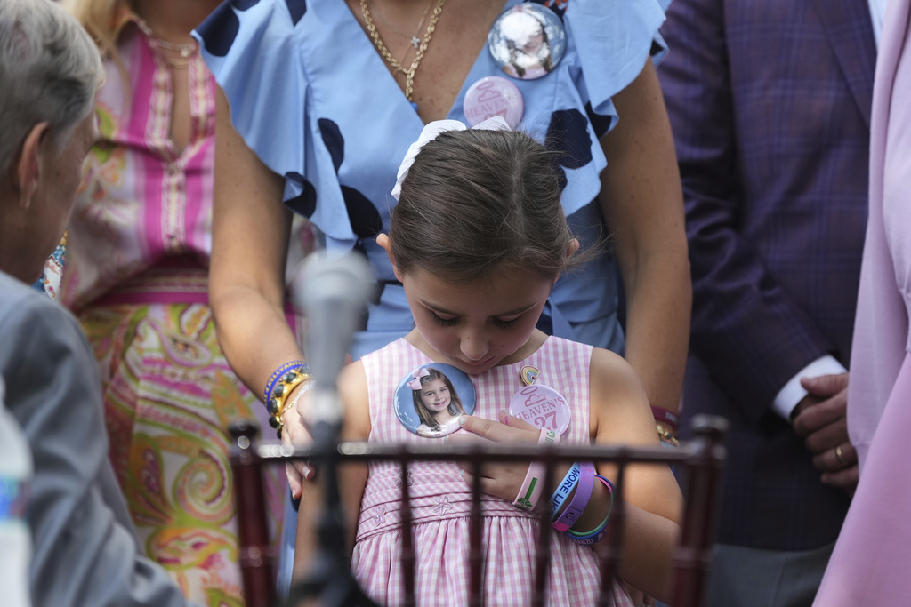 Texas Gov. Greg Abbott, left, visits with parents and family of children who died at Camp Mystic as he prepares to sign camp safety bills, Friday, Sept. 5, 2025, in Austin, Texas. (AP Photo/Eric Gay)