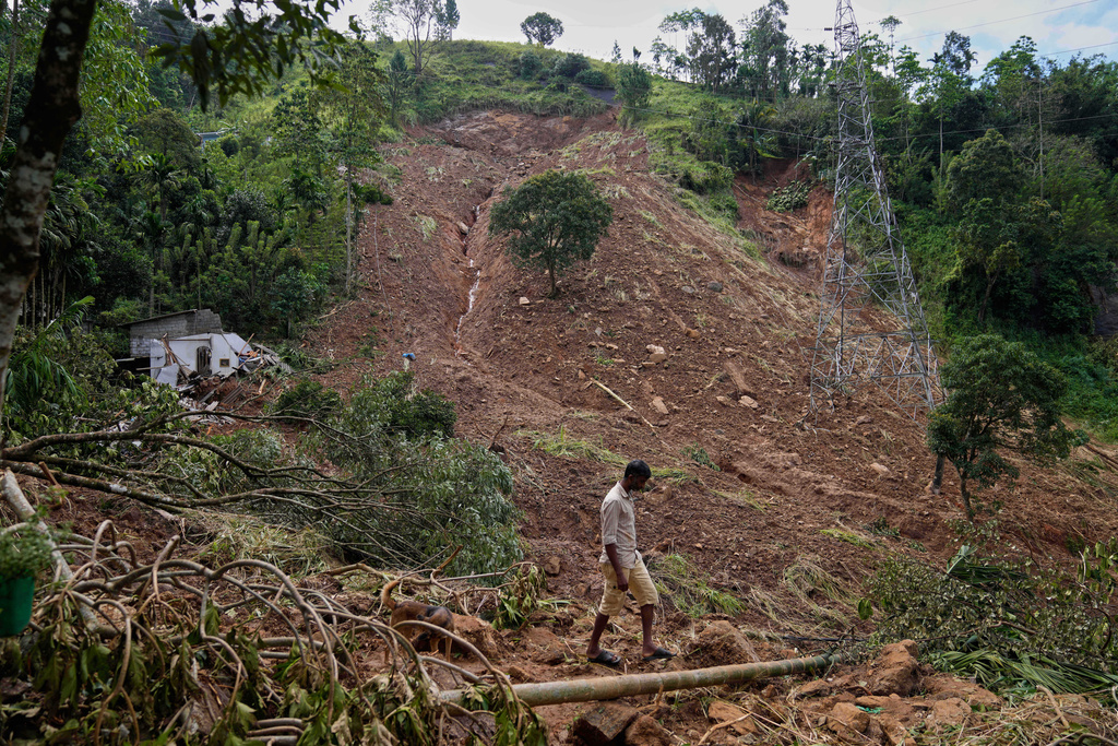 FILE - A landslide survivor searches for belongings at the site in the aftermath of Cyclone Ditwah in Sarasavigama village in Kandy, Sri Lanka, Dec. 1, 2025. (AP Photo/Eranga Jayawardena, File)