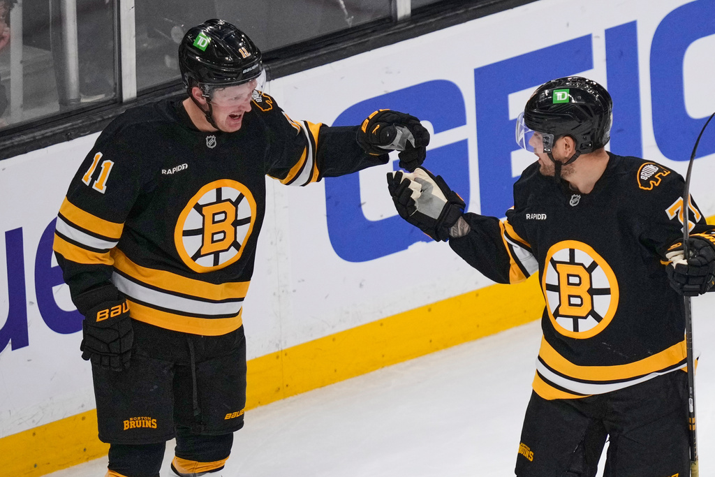 Boston Bruins center Casey Mittelstadt (11) is congratulated by left wing Viktor Arvidsson, right, after his goal against the Winnipeg Jets during the second period of an NHL hockey game, Thursday, March 19, 2026, in Boston. (AP Photo/Charles Krupa)